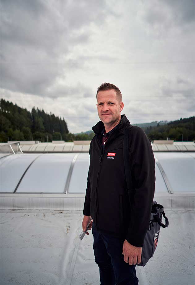 A man in front of the VARIO-NORM continuous rooflight on the roof