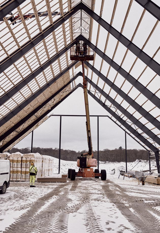 A crane lifting rooflight installations on a building project