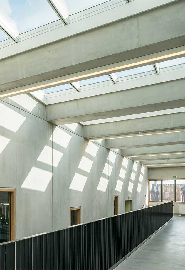 The VELUX atrium Longlight of 40 modules brings natural daylight into the large stairwell of ZAVO school, Belgium